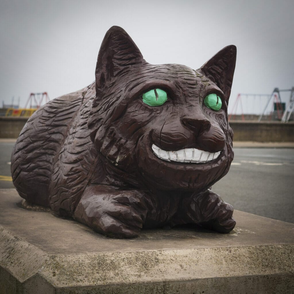 Photos of Alice and Wonderland Wooden Statues in Llandudno as part of the White Rabbit Trail