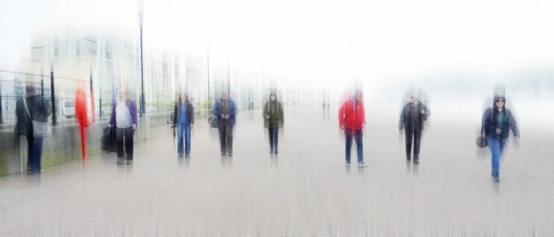 A blurred image (intentional camera movement) of a group of people socially distancing walking along the Llandudno Prom in North Wales. Taken on a Welshot Photographic Workshops and Events