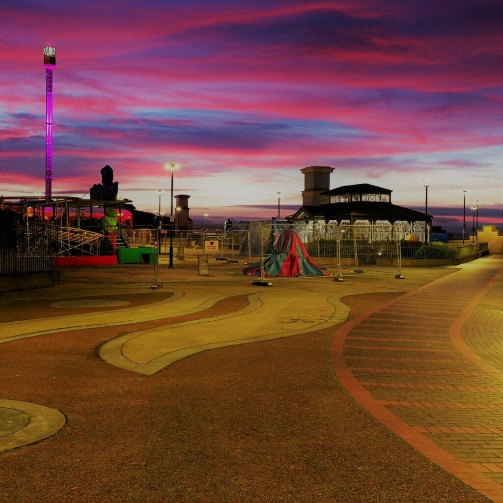 Photo of the Children's playground in Rhyl, North Wales - Taken in low-light with the sun going down and showing a red / purple sky