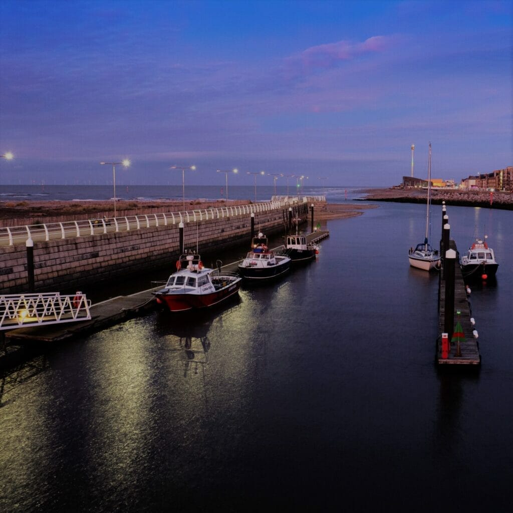 Photo taken at night of the new harbour in Rhyl, North Wales with fishing boats - taken on a Low-Light and Long Exposure Photography - Rhyl - Roving Academy Evening workshop with Welshot