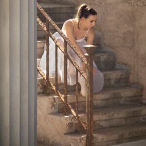 Photo of a Ballet Dancer sitting on some steps in Llandudno - Dancing on Location - Off Camera Flash Photography
