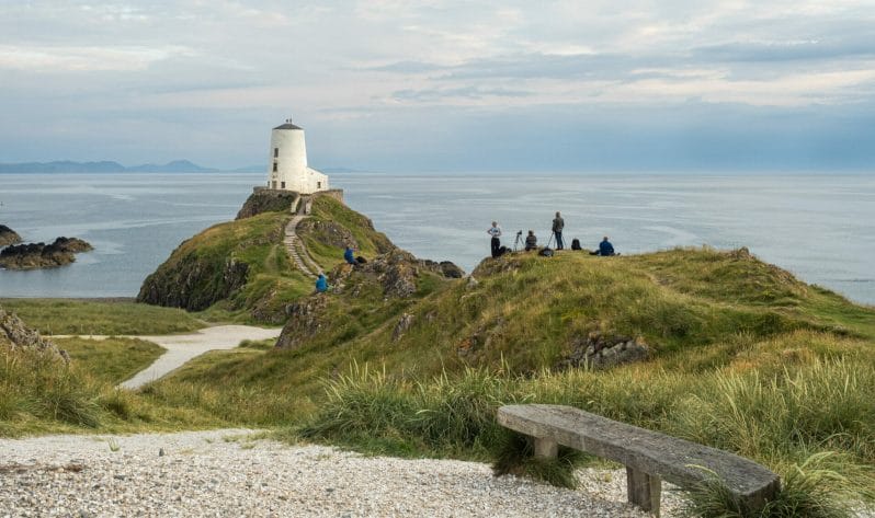 Photo of a group of photographers on a Welshot Photographic Academy Event taking photos of the old lighthouse on Llanddwyn Island, Anglesey