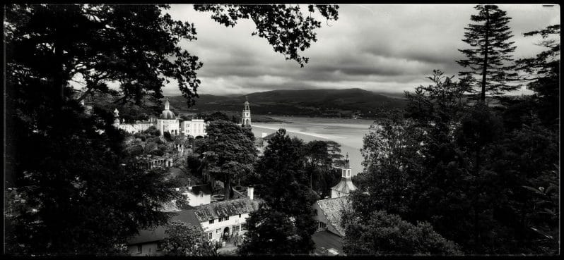 Black and White Photo of the Portmeirion Village in North Wales taken from a hillside viewpoint overlooking the estuary.