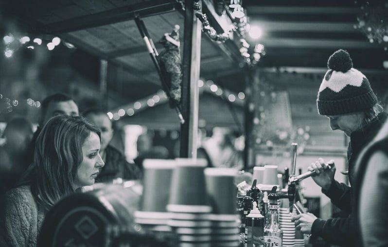 Black and White Photo of someone serving drinks at the Chester Christmas Markets
