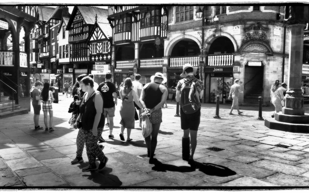 Black and White Photo of a group of people in the streets of Chester. The photos was taken on the Chester Walls - A Photographic Adventure with Welshot