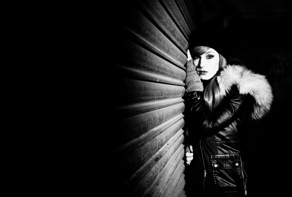 Off Camera Flash Photography- Castlefields Manchester - Black and White Photo of a Model leaning against a wall