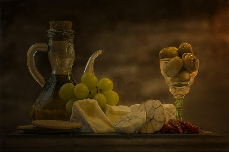 Food Styling & Photography - Anglesey Photographic Academy Evening - Photo showing Glass jar of Olive Oil, Olives, Garlic and Cheese