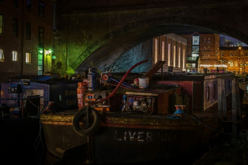 Colour Photograph showing old canal barges and junk alongside the Castlefield Canal Basin Creative Cityscape Photography