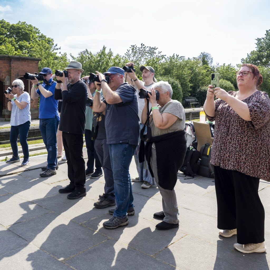 A photo of a group of people all lining up to take a photo